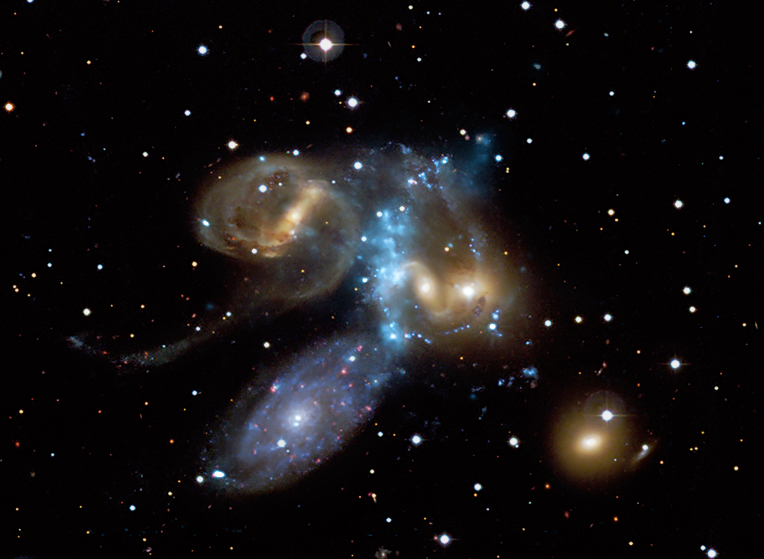 X-ray/optical image of Stephan's Quintet, a group of five galaxies, in which an infalling galaxy has shock heated an intergalactic gas filament to several million degrees.